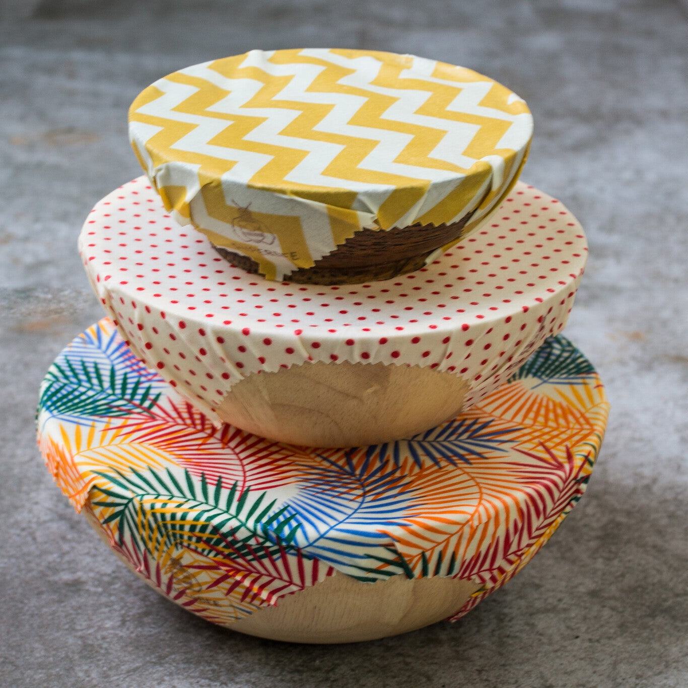 A set of 3 different sized bowls are covered using SuperBee Beeswax Food Wraps.